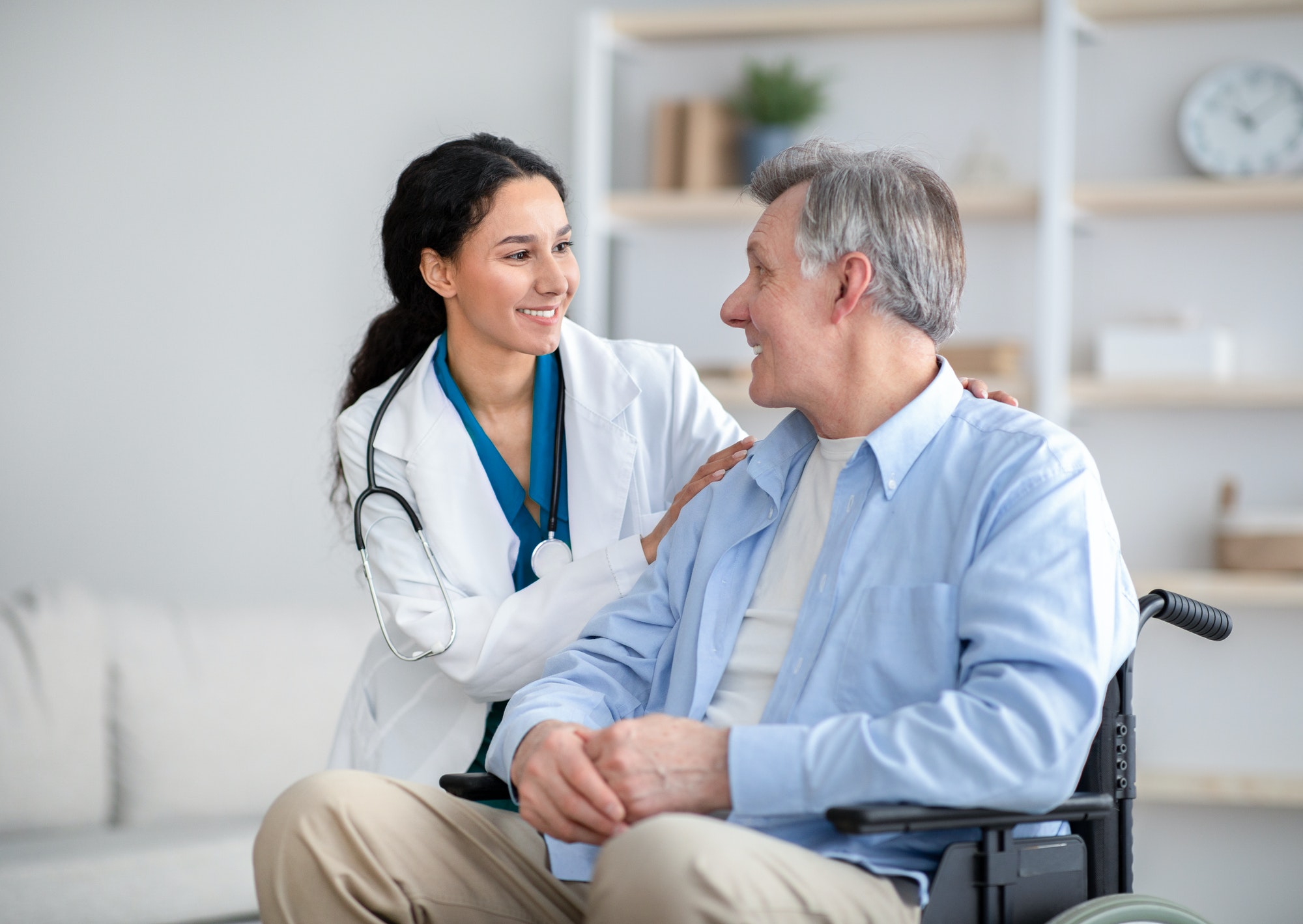 impaired-senior-man-in-wheelchair-and-young-nurse-taking-care-of-him-at-home.jpg